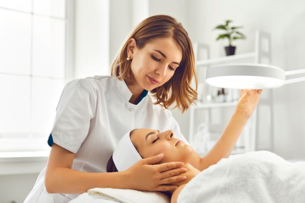 esthetician looking at patients face